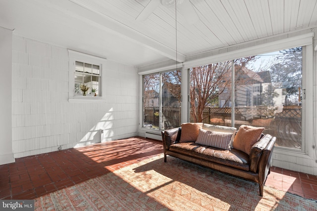 sunroom / solarium with beamed ceiling, baseboard heating, and plenty of natural light