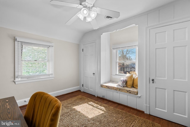 office area featuring lofted ceiling, baseboards, visible vents, and wood finished floors