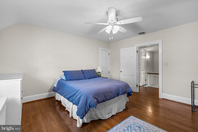 bedroom with a ceiling fan, wood finished floors, visible vents, and baseboards