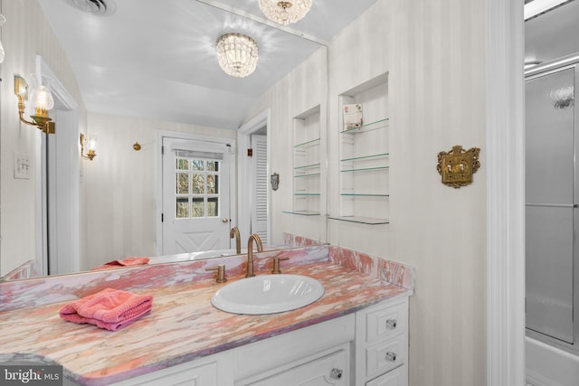 full bathroom featuring a chandelier, an enclosed shower, and vanity