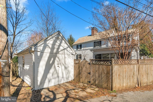 view of outbuilding with an outbuilding, a gate, and fence