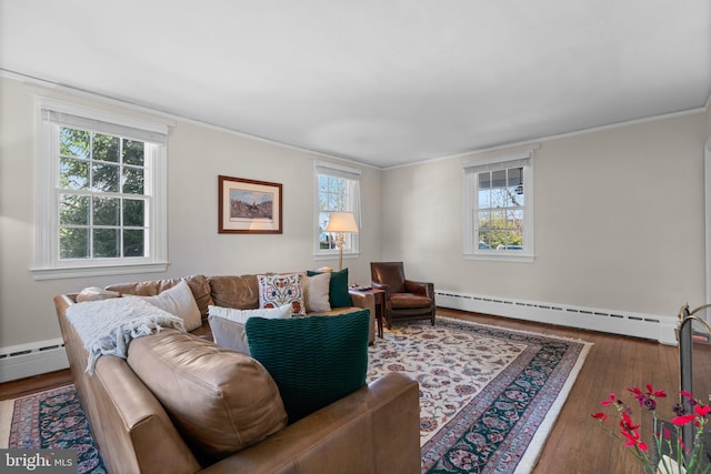 living area featuring hardwood / wood-style flooring, a baseboard radiator, and ornamental molding