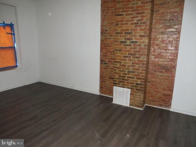 unfurnished room with dark wood-type flooring