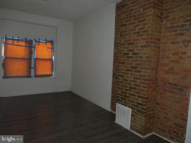 spare room with dark wood-type flooring