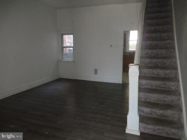 spare room with dark wood-type flooring