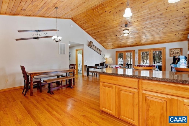 kitchen featuring decorative light fixtures, lofted ceiling, wood ceiling, light wood-type flooring, and french doors