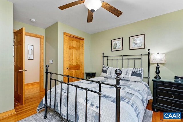 bedroom with ceiling fan and hardwood / wood-style floors