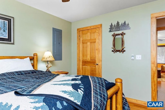 bedroom featuring wood-type flooring and electric panel