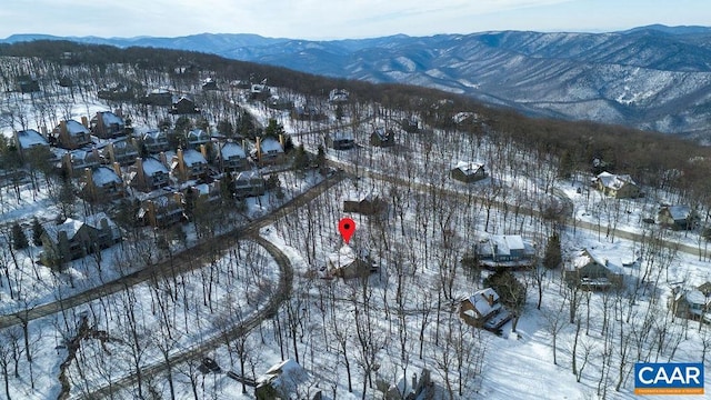 snowy aerial view with a mountain view