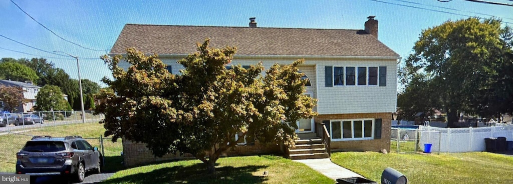 rear view of house with a lawn