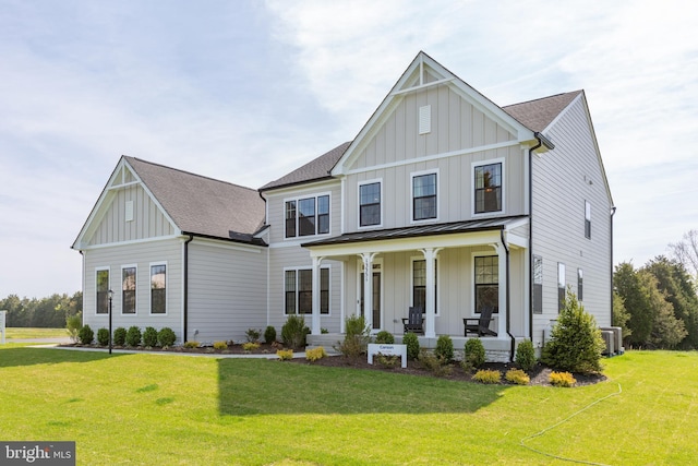 modern inspired farmhouse with cooling unit, covered porch, and a front lawn