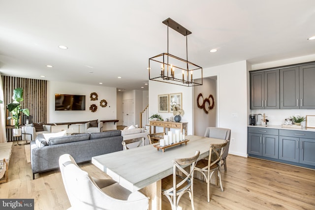 dining area with a notable chandelier and light wood-type flooring