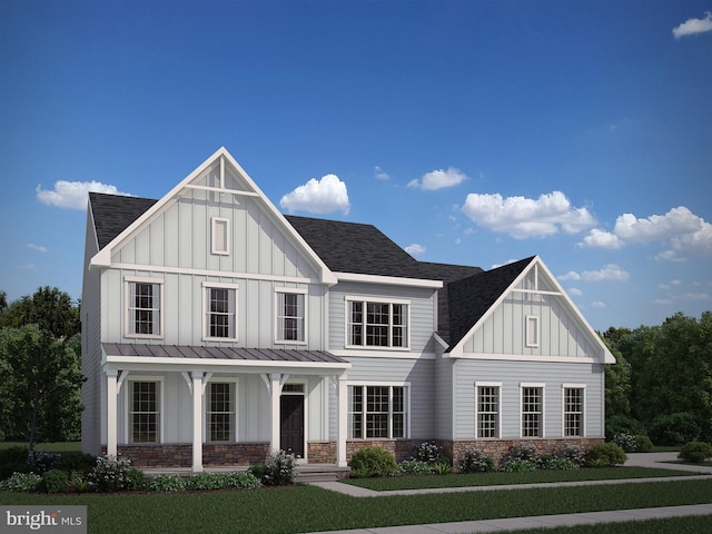 modern farmhouse style home with a front lawn