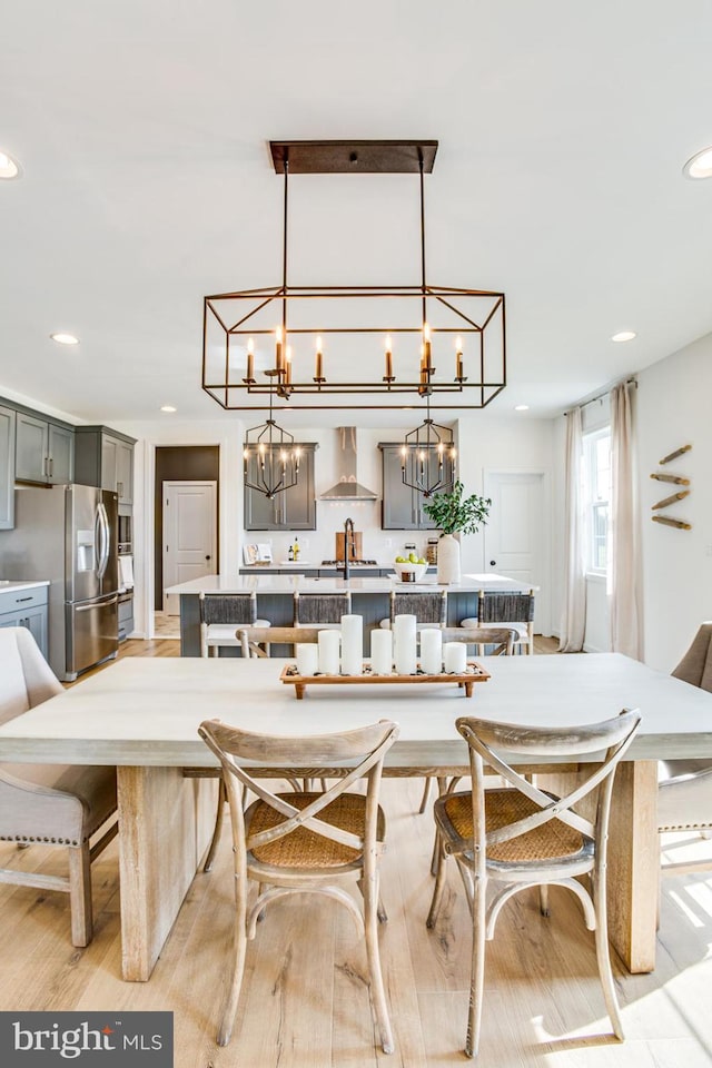 dining room with sink and light wood-type flooring