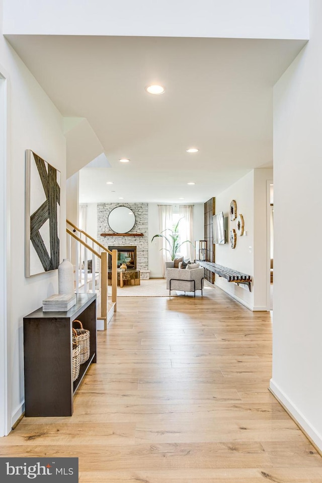 corridor with light hardwood / wood-style floors