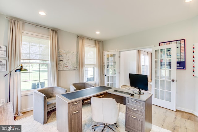 home office featuring light wood-type flooring and french doors