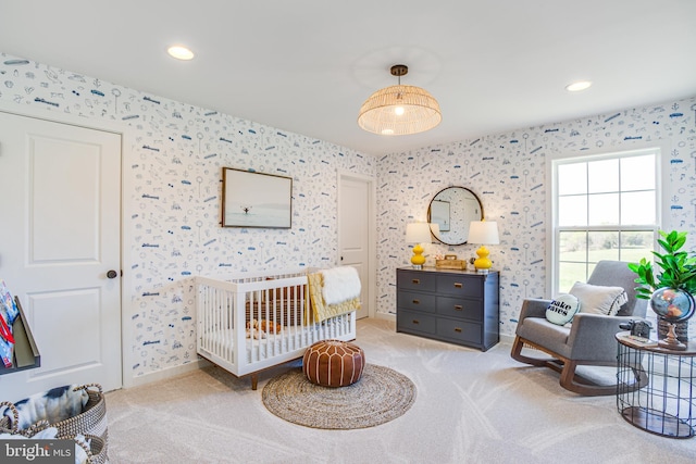 carpeted bedroom featuring a crib