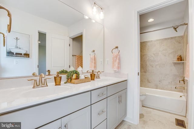 full bathroom with tiled shower / bath combo, vanity, tile patterned floors, and toilet