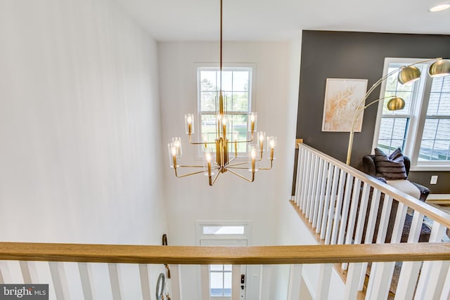 stairway with a chandelier