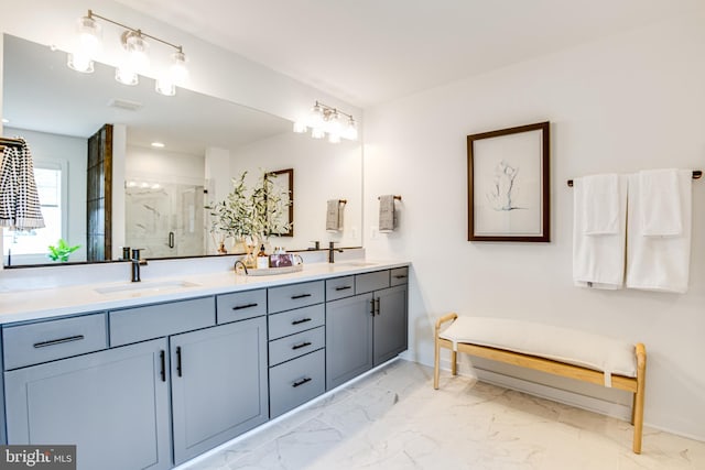 bathroom with vanity and a shower with door