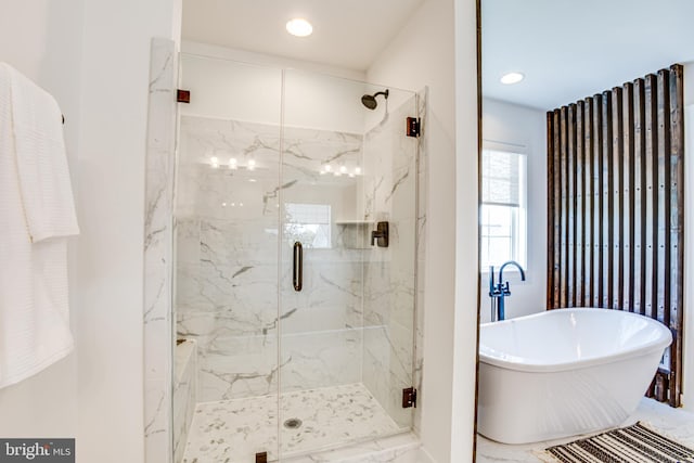 bathroom with shower with separate bathtub