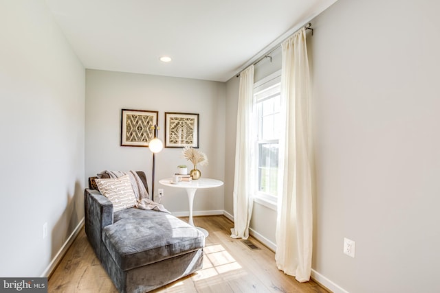 sitting room with a wealth of natural light and light hardwood / wood-style floors