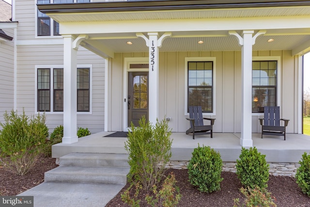 view of exterior entry featuring a porch