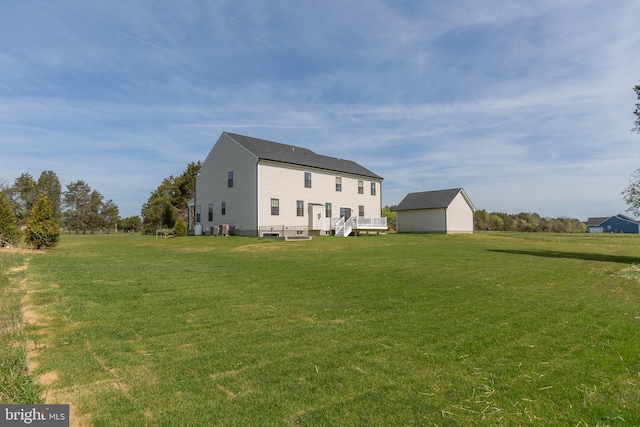 rear view of property featuring a yard and a deck