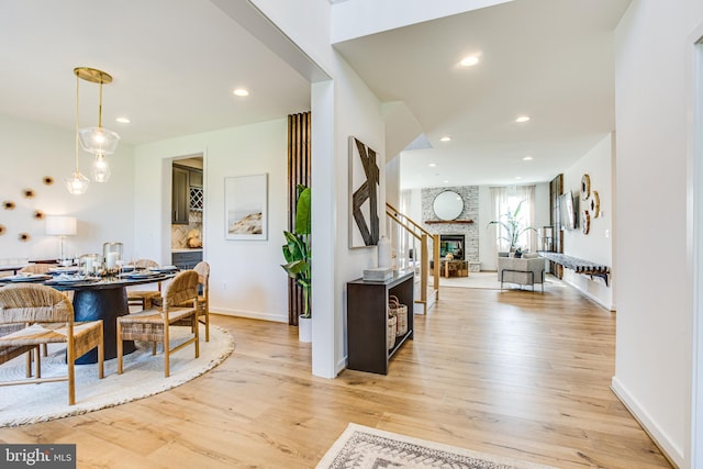 entryway featuring light hardwood / wood-style floors and a large fireplace