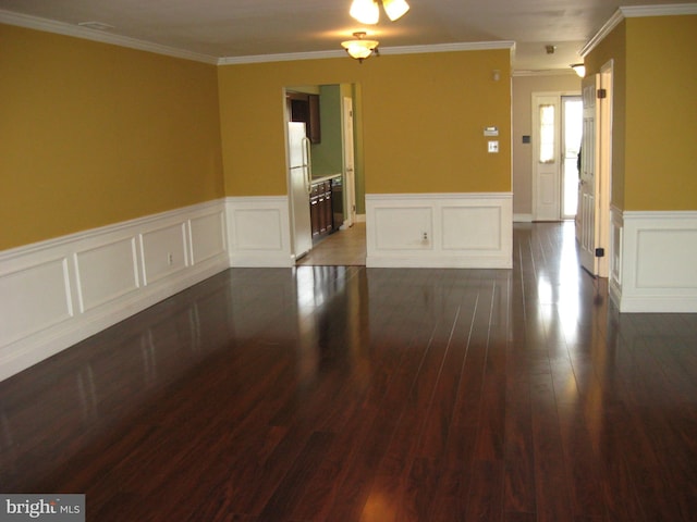 unfurnished room with ornamental molding and dark hardwood / wood-style flooring