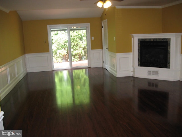 unfurnished living room featuring dark wood-type flooring, ceiling fan, a high end fireplace, and vaulted ceiling