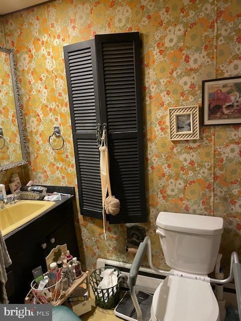 bathroom featuring vanity and toilet