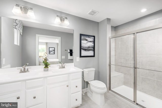 bathroom with walk in shower, vanity, toilet, and tile patterned flooring