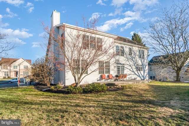 rear view of house featuring a lawn and a patio area