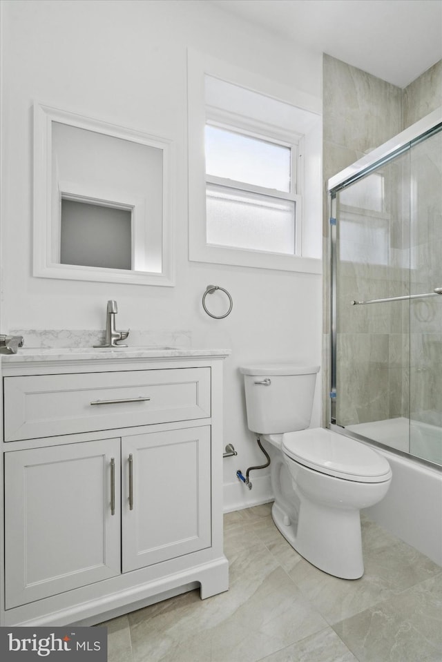 full bathroom with vanity, combined bath / shower with glass door, and toilet