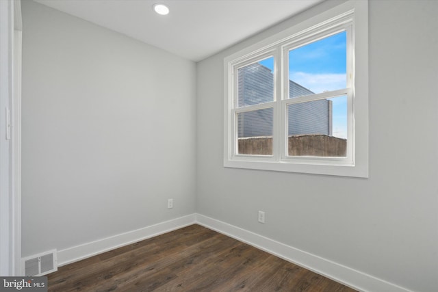 unfurnished room featuring dark hardwood / wood-style floors