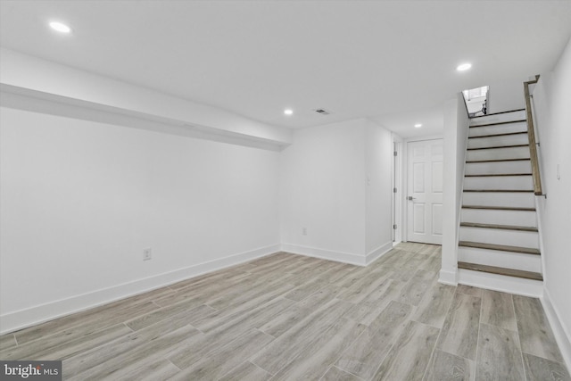 basement with light hardwood / wood-style floors