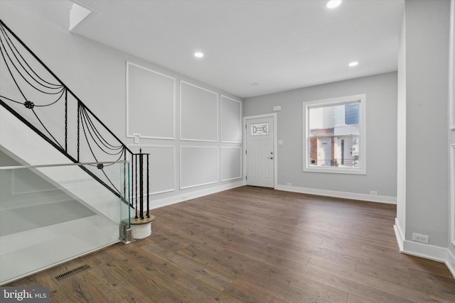 foyer entrance featuring dark wood-type flooring