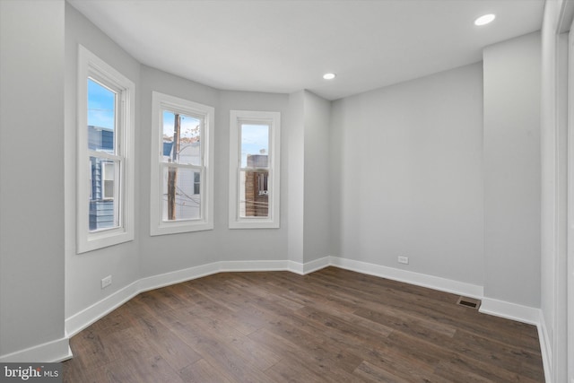 empty room featuring dark hardwood / wood-style flooring