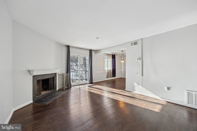 unfurnished living room with dark hardwood / wood-style floors