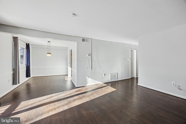 spare room featuring dark hardwood / wood-style flooring