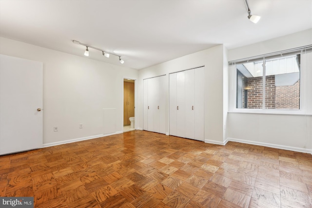 unfurnished bedroom featuring light parquet floors