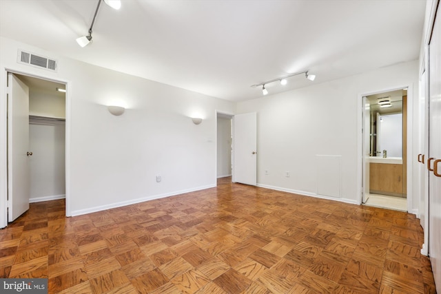 spare room featuring parquet floors