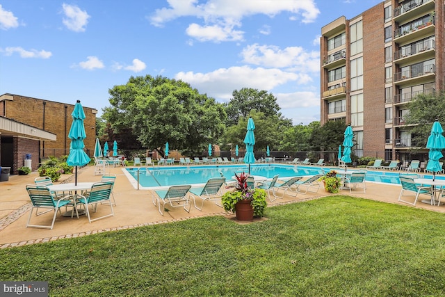 view of pool with a yard and a patio area