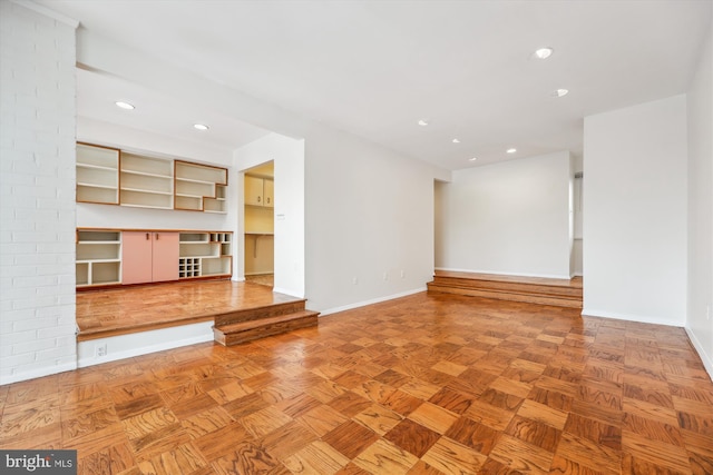 unfurnished living room with light parquet floors