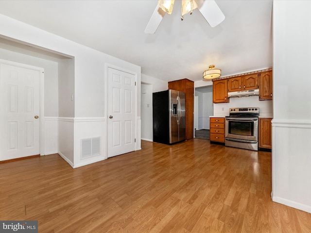 kitchen featuring light hardwood / wood-style floors, ceiling fan, and appliances with stainless steel finishes