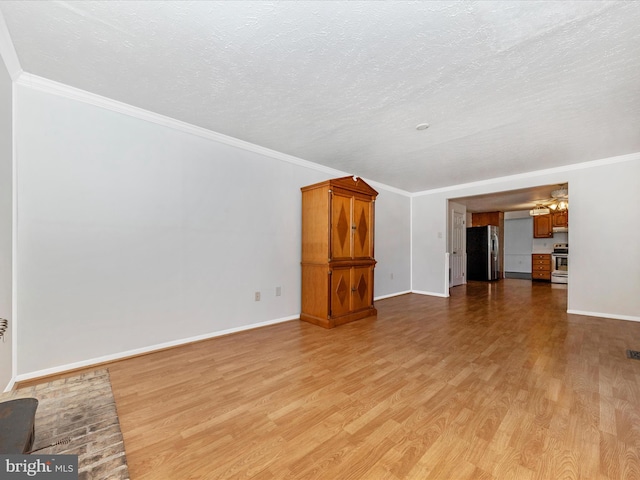 unfurnished living room featuring light hardwood / wood-style flooring, ornamental molding, and a textured ceiling