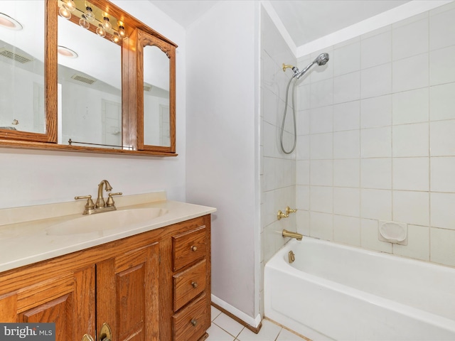 bathroom with vanity, tile patterned floors, and tiled shower / bath