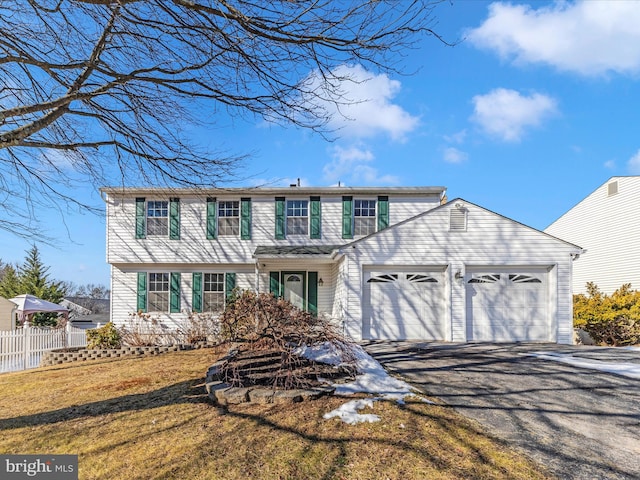 view of front of property featuring a garage and a front yard