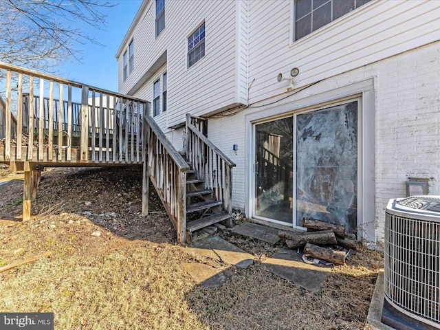 exterior space featuring a wooden deck and central AC